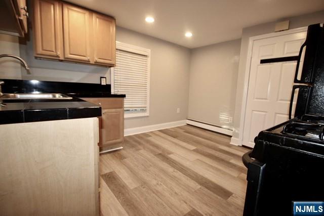 323 Maple Avenue, Unit 2 Oradell, NJ 07649 - Photo 8 of 8 a kitchen with a refrigerator stove and a sink