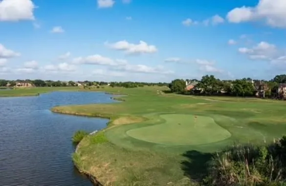 a view of a golf course with a lake