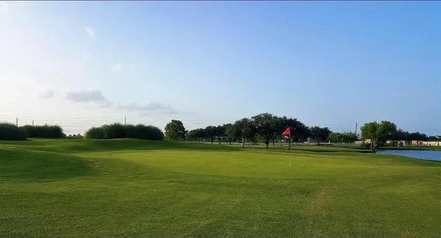 a view of a lake with houses in back