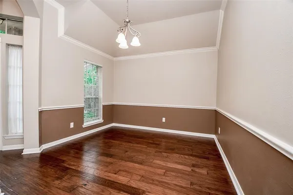 a view of room with window and wooden floor