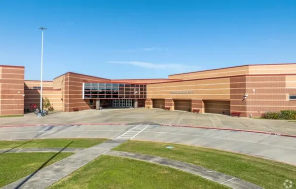 a front view of building with yard