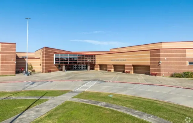 a front view of building with yard