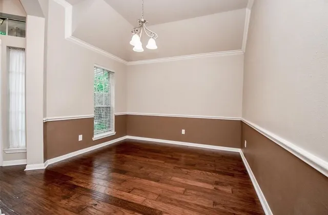 a view of room with window and wooden floor