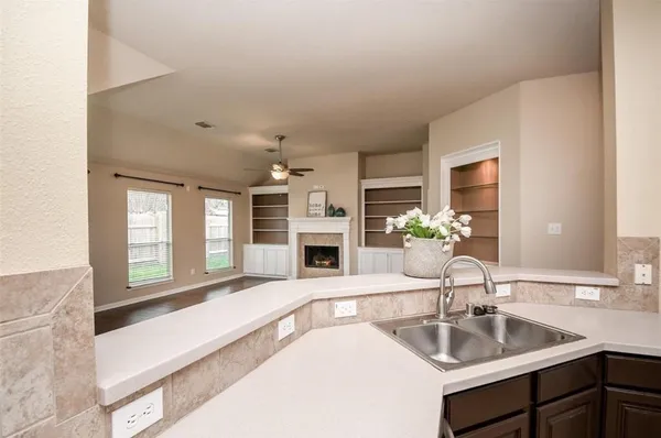 a kitchen with a sink and a large mirror