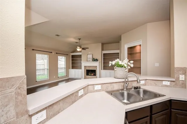 a kitchen with a sink and a large mirror