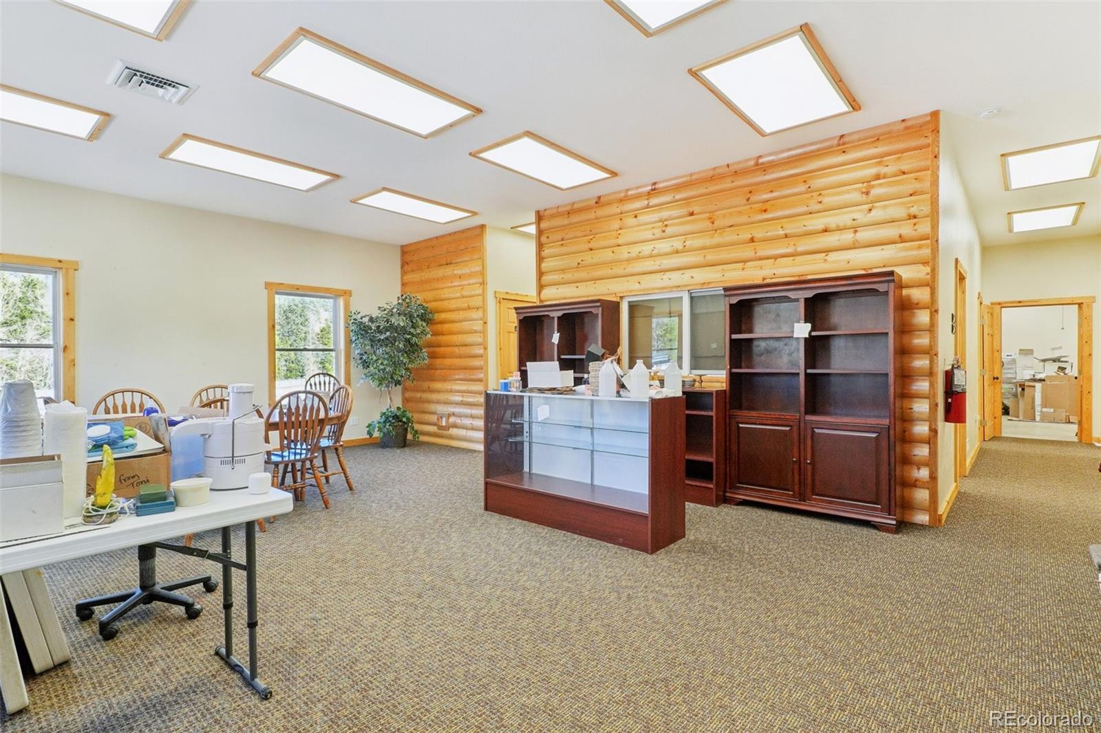 4628 Smith Hill Road Golden, CO 80403 - Photo 12 of 49 a living room with furniture a flat screen tv and kitchen view