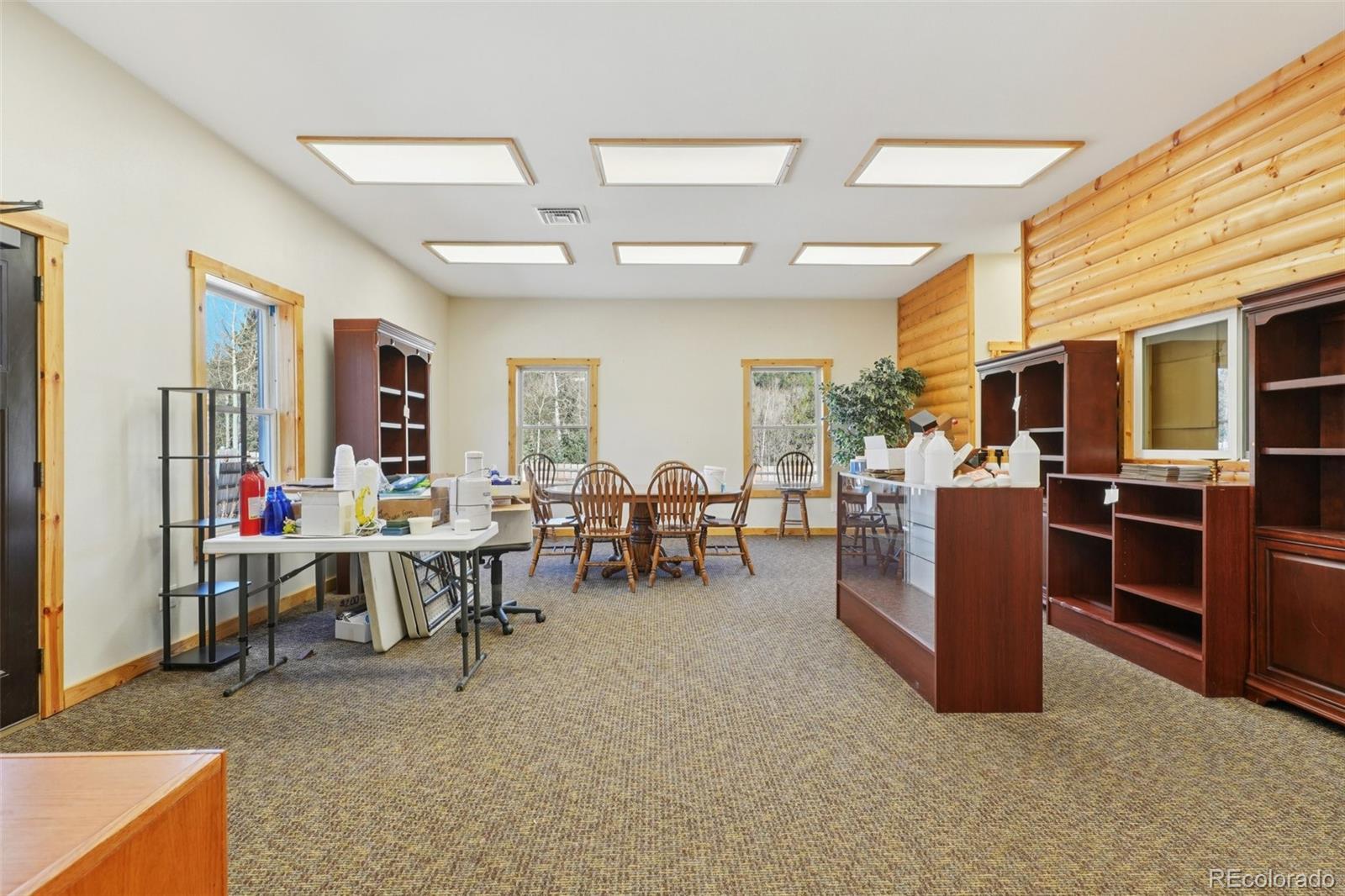 4628 Smith Hill Road Golden, CO 80403 - Photo 13 of 49 a living room with lots of furniture and clutter