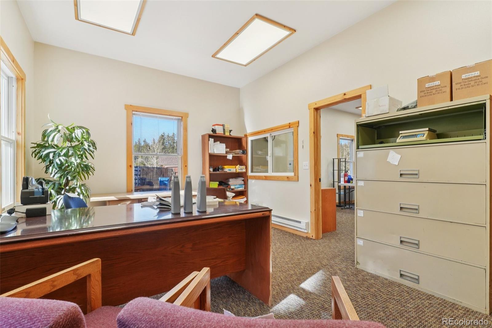 4628 Smith Hill Road Golden, CO 80403 - Photo 16 of 49 a room with wooden floor and furniture