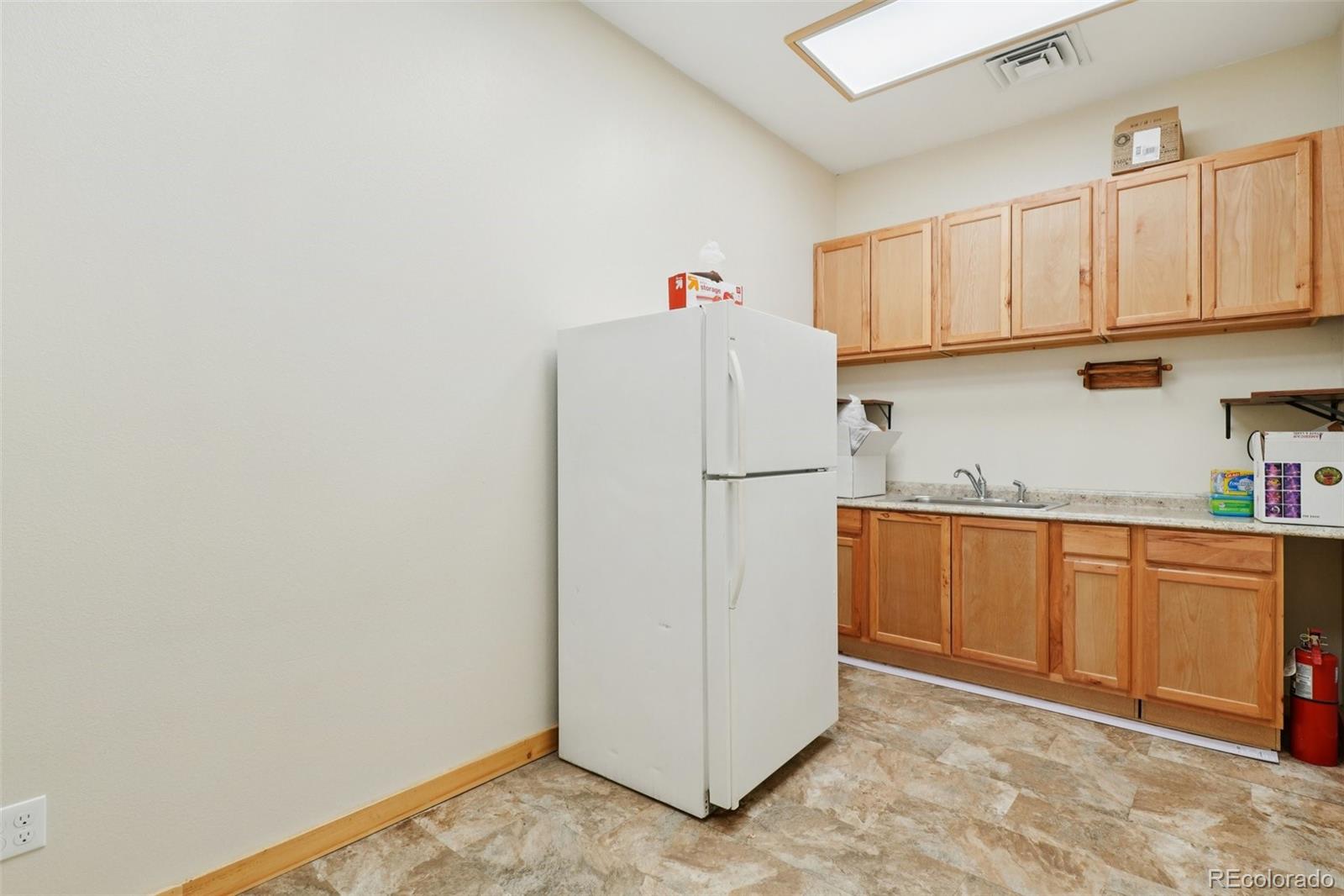 4628 Smith Hill Road Golden, CO 80403 - Photo 17 of 49 a kitchen with cabinets and white appliances