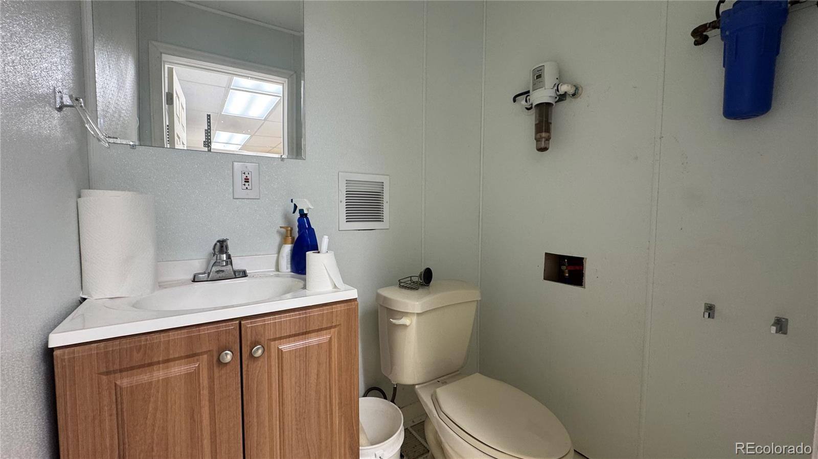 4628 Smith Hill Road Golden, CO 80403 - Photo 27 of 49 a bathroom with a sink vanity mirror and toilet