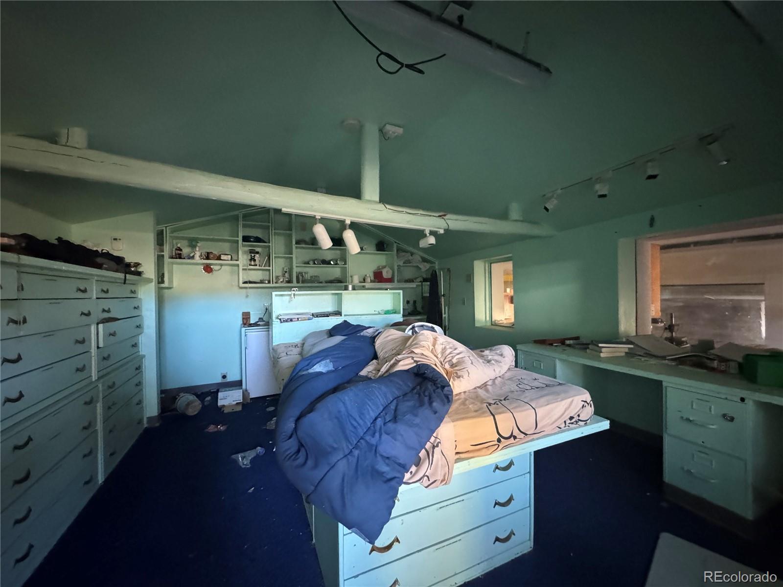 4628 Smith Hill Road Golden, CO 80403 - Photo 38 of 49 a bed room with a bed and a window