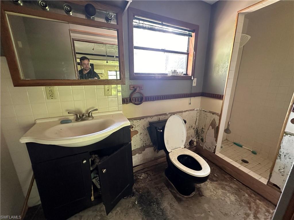 1132 Donald Road North Fort Myers, FL 33917 - Photo 14 of 21 a bathroom with a sink a toilet and a mirror