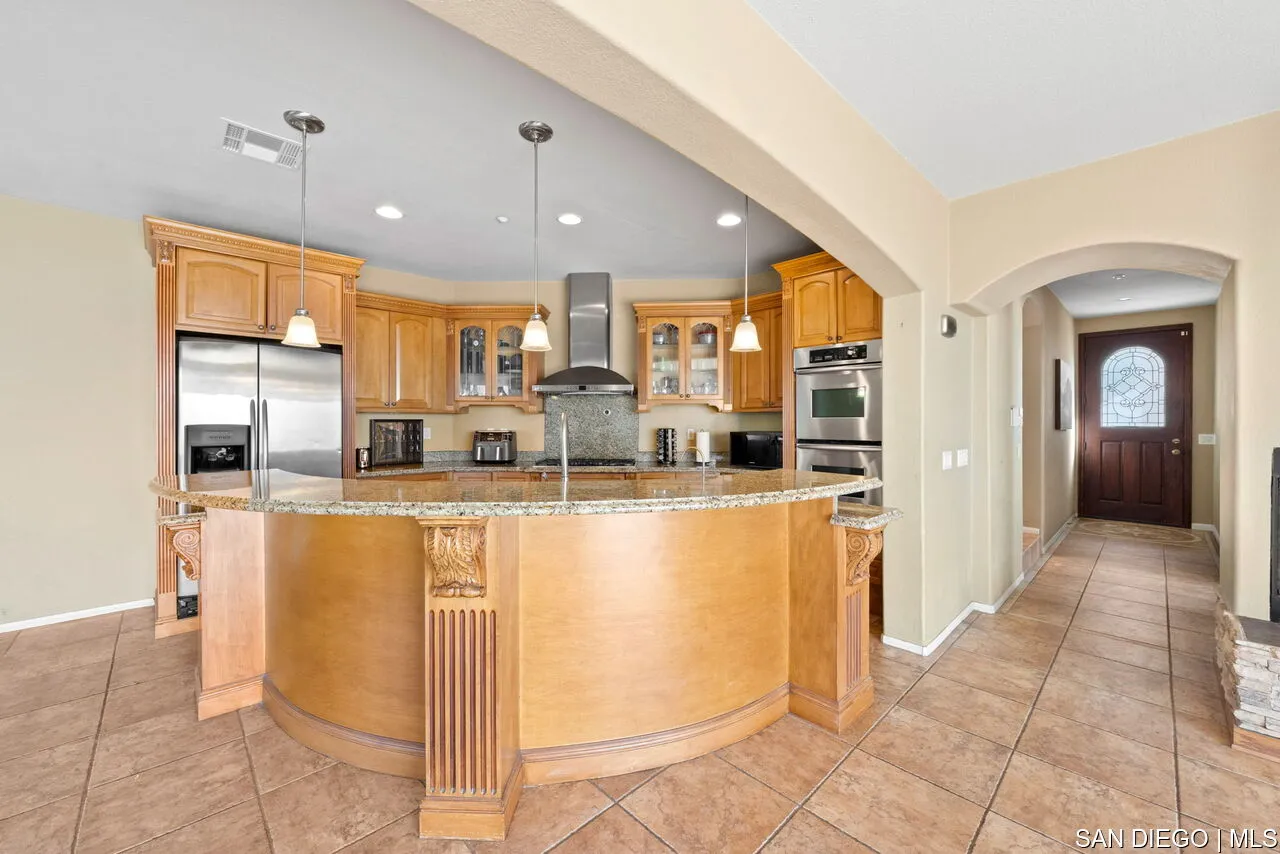 9648 Eucalyptus Street Spring Valley, CA 91977 - Photo 11 of 39 a view of a kitchen with stainless steel appliances granite countertop a refrigerator and a sink