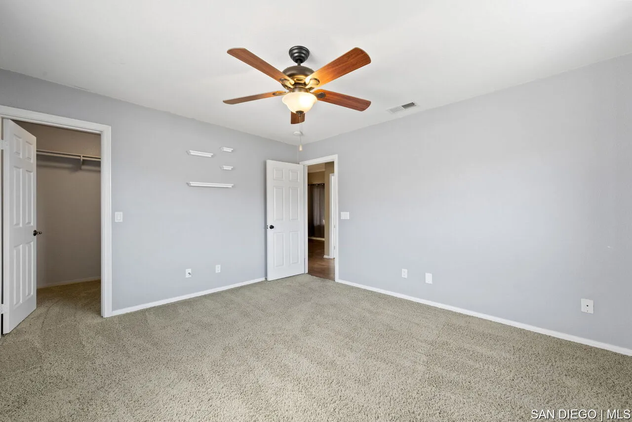 9648 Eucalyptus Street Spring Valley, CA 91977 - Photo 20 of 39 an empty room with closet and ceiling fan