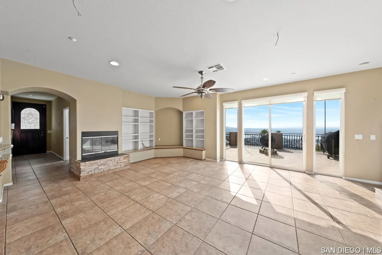 9648 Eucalyptus Street Spring Valley, CA 91977 - Photo 8 of 39 a view of a hallway with wooden floor and a living room