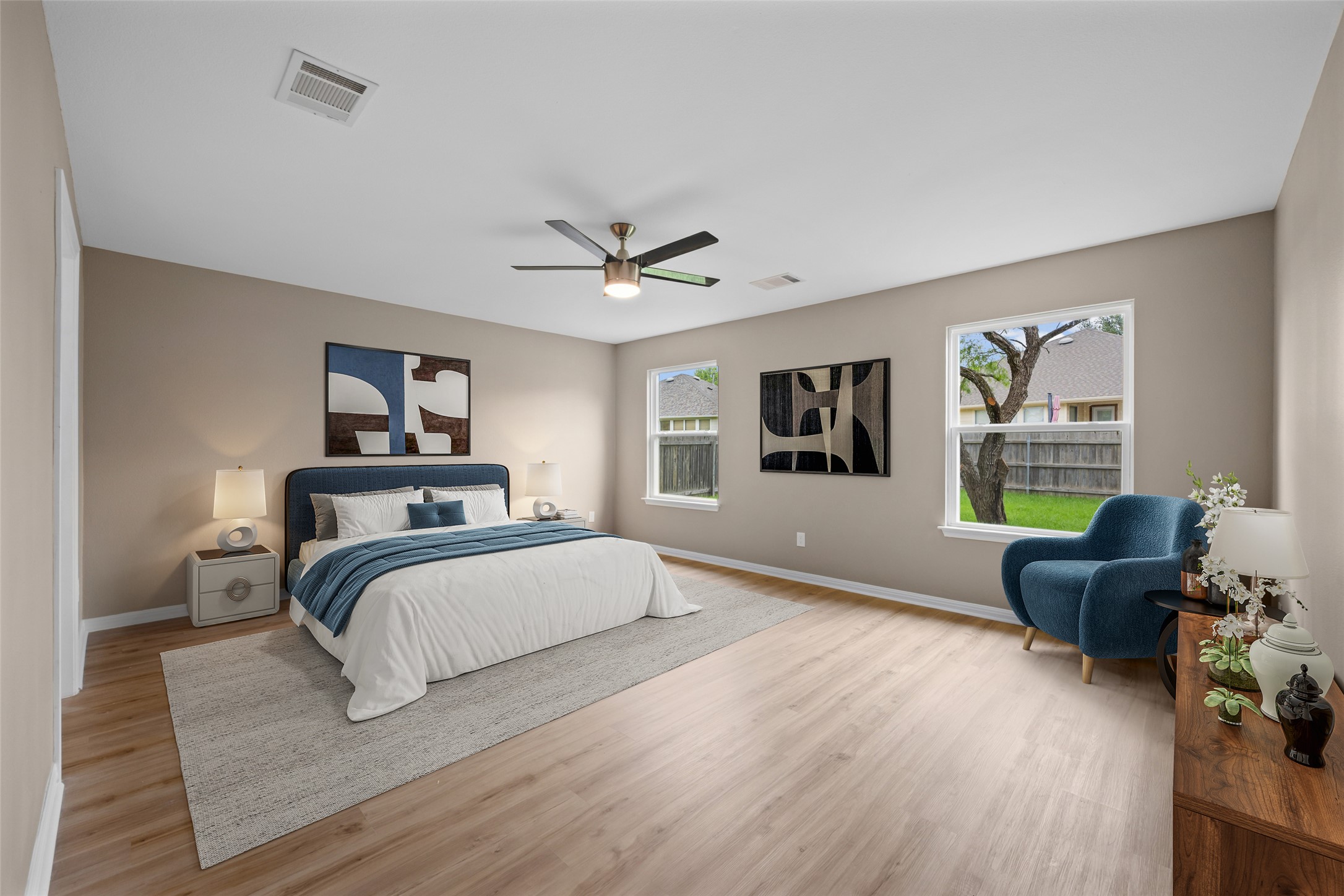 107 Pheasant Ridge Drive Round Rock, TX 78665 - Photo 17 of 40 Spacious room featuring wood-finish flooring, neutral-toned walls, multiple windows with white trim, a ceiling fan with integrated lighting, and recessed lighting