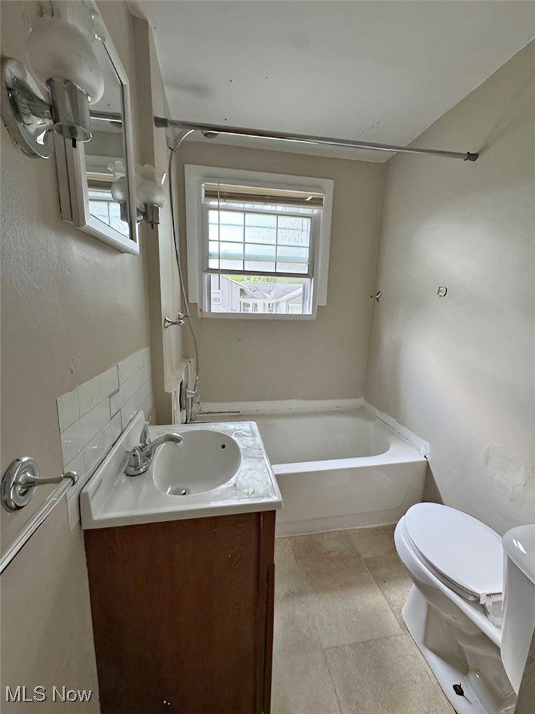 254 Howland Wilson Road Southeast Warren, OH 44484 - Photo 6 of 9 Full bathroom featuring shower / washtub combination, vanity, tile patterned flooring, and toilet