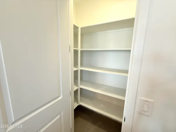 a kitchen with stainless steel appliances kitchen island a refrigerator and a wooden floor