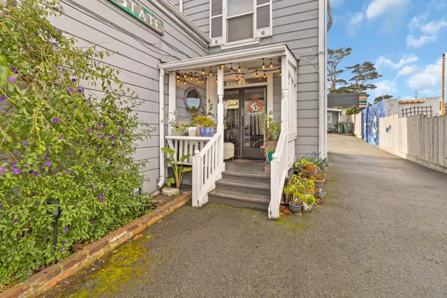 a view of a chair and table in front of house
