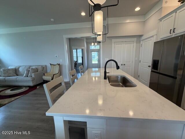 203 Farmstead Loop Moyock, NC 27958 - Photo 17 of 75 OPEN KITCHEN WITH QUARTZ COUNTER TOPS, SOFT CLOSE CABINETRY, GAS RANGE, MICROWAVE, DISHWASHER AND 2ND WALL OVEN, OVER/UNDER CABINTRY LIGHTING, DEEP SINK IN ISLAND, THIS IS THE CENTRAL POINT OF THE DOWNSTAIRS AREA.