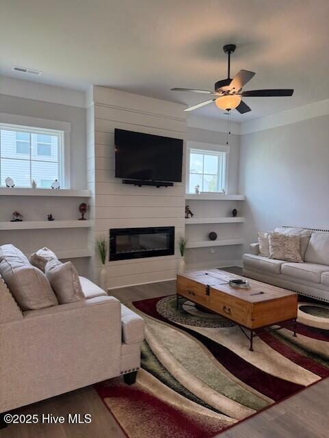 203 Farmstead Loop Moyock, NC 27958 - Photo 31 of 75 GREAT ROOM WITH BUILT IN FLOATING SHELVING ON BOTH SIDES OF THE 48" LINEAR FIREPLACE.