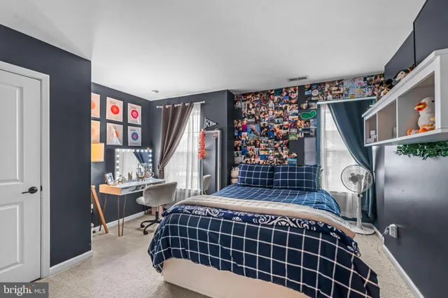 a bedroom with a bed and a flat tv screen