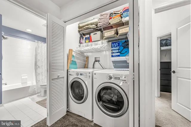 a bedroom with a bed and a flat tv screen on the dresser