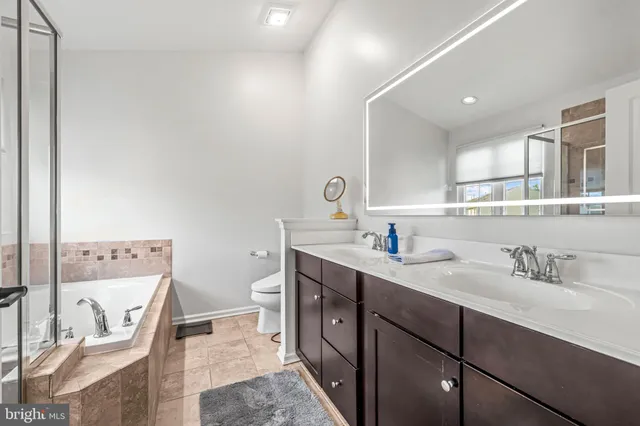 a bathroom with a tub sink and shower