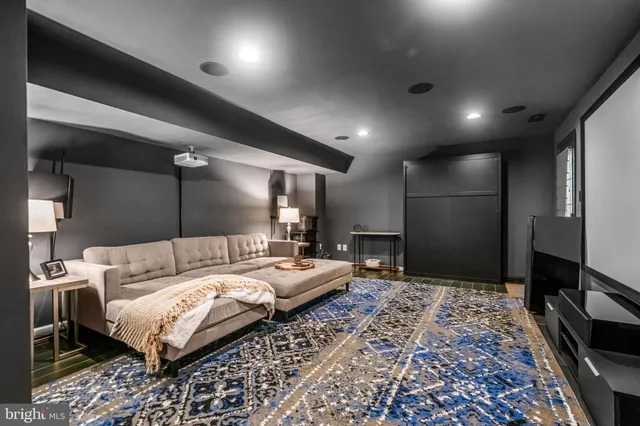 a large bedroom with a bed a desk and chair