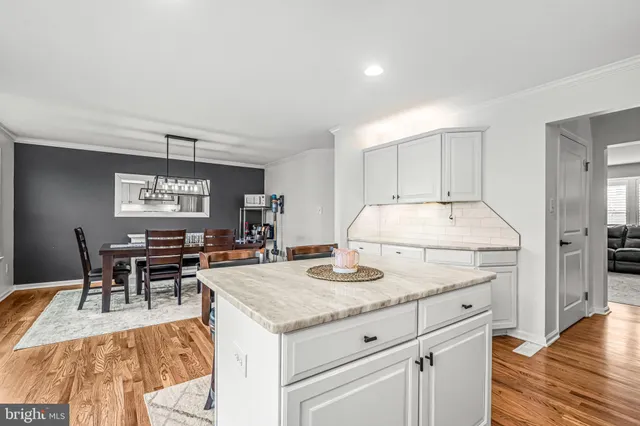 a kitchen with a refrigerator and a stove top oven