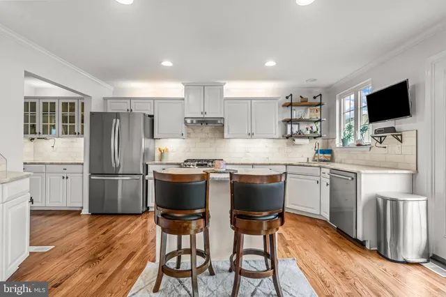 a kitchen with stainless steel appliances a refrigerator stove microwave and cabinets