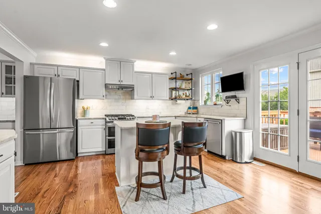 a dining room with furniture and wooden floor