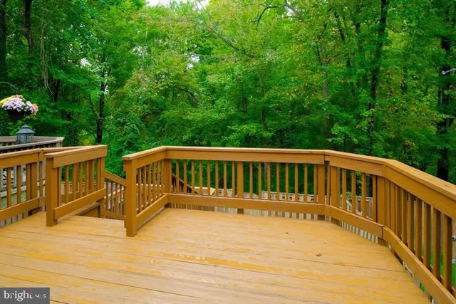 a view of a wooden deck and backyard