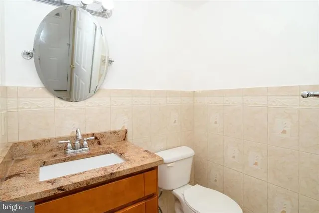 a kitchen with stainless steel appliances granite countertop a stove a sink and white cabinets