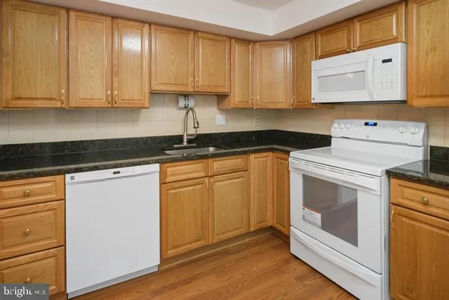 a view of a room with a door and wooden floor