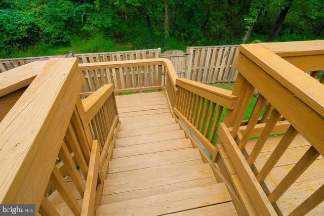 a view of wooden house with a small deck