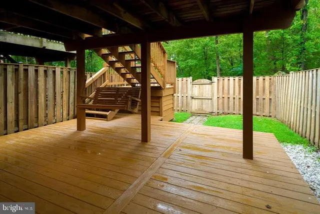 a view of porch with wooden floor and a fence