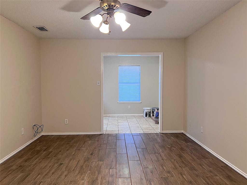 1106 Curtis Drive, Unit A Weatherford, TX 76086 - Photo 4 of 13 wooden floor in an empty room with a window