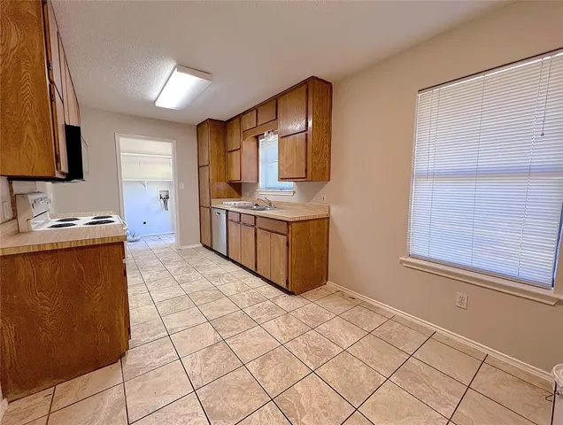 a kitchen with stainless steel appliances granite countertop a sink stove and microwave