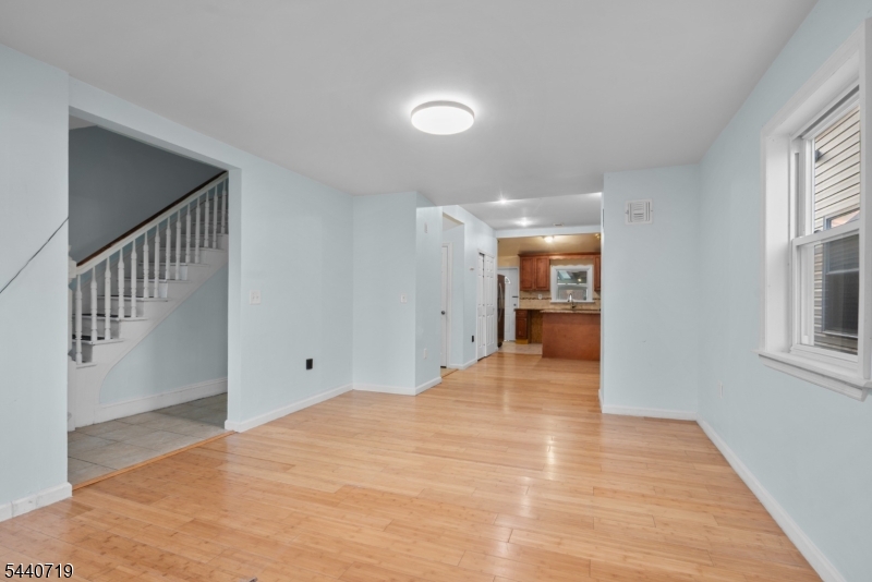 136 Smith Street Elizabeth, NJ 07201 - Photo 6 of 38 a view of a hallway with wooden floor and kitchen
