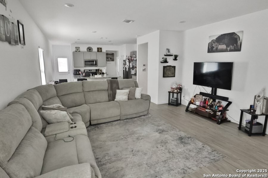5867 Hematite Rim San Antonio, TX 78222 - Photo 3 of 16 a living room with furniture and a flat screen tv