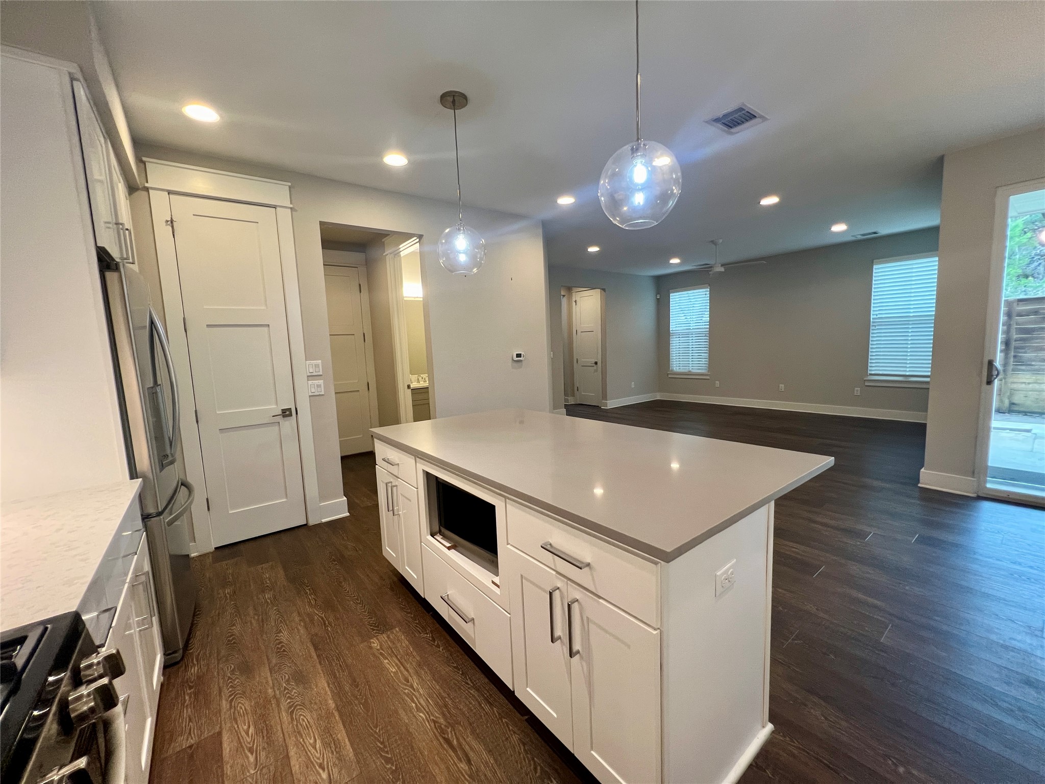 6515 Davis Lane, Unit 10 Austin, TX 78749 - Photo 7 of 22 A contemporary kitchen island grounds an open-concept living area with seamless indoor-outdoor flow.