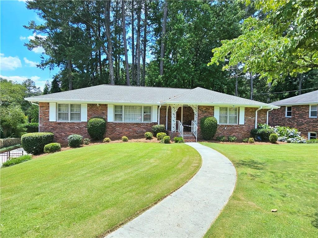1738 Alderbrook Road Northeast Atlanta, GA 30345 - Photo 1 of 1 a front view of a house with a yard table and chairs