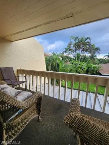 a view of a chairs and table in the balcony