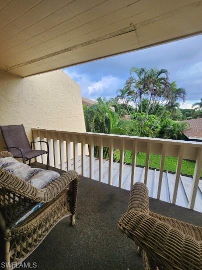 925 Palm View Drive, Unit F120 Naples, FL 34110 - Photo 14 of 22 a view of a chairs and table in the balcony
