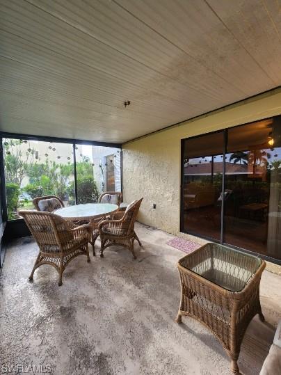 925 Palm View Drive, Unit F120 Naples, FL 34110 - Photo 21 of 22 a outdoor space with a couch and chairs