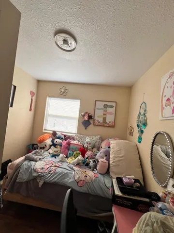 a bedroom with a bed and dresser