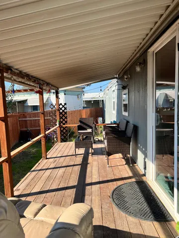 a view of a patio with table and chairs