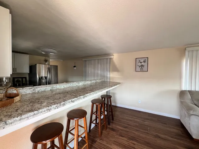 a view of kitchen island wooden floor and living room