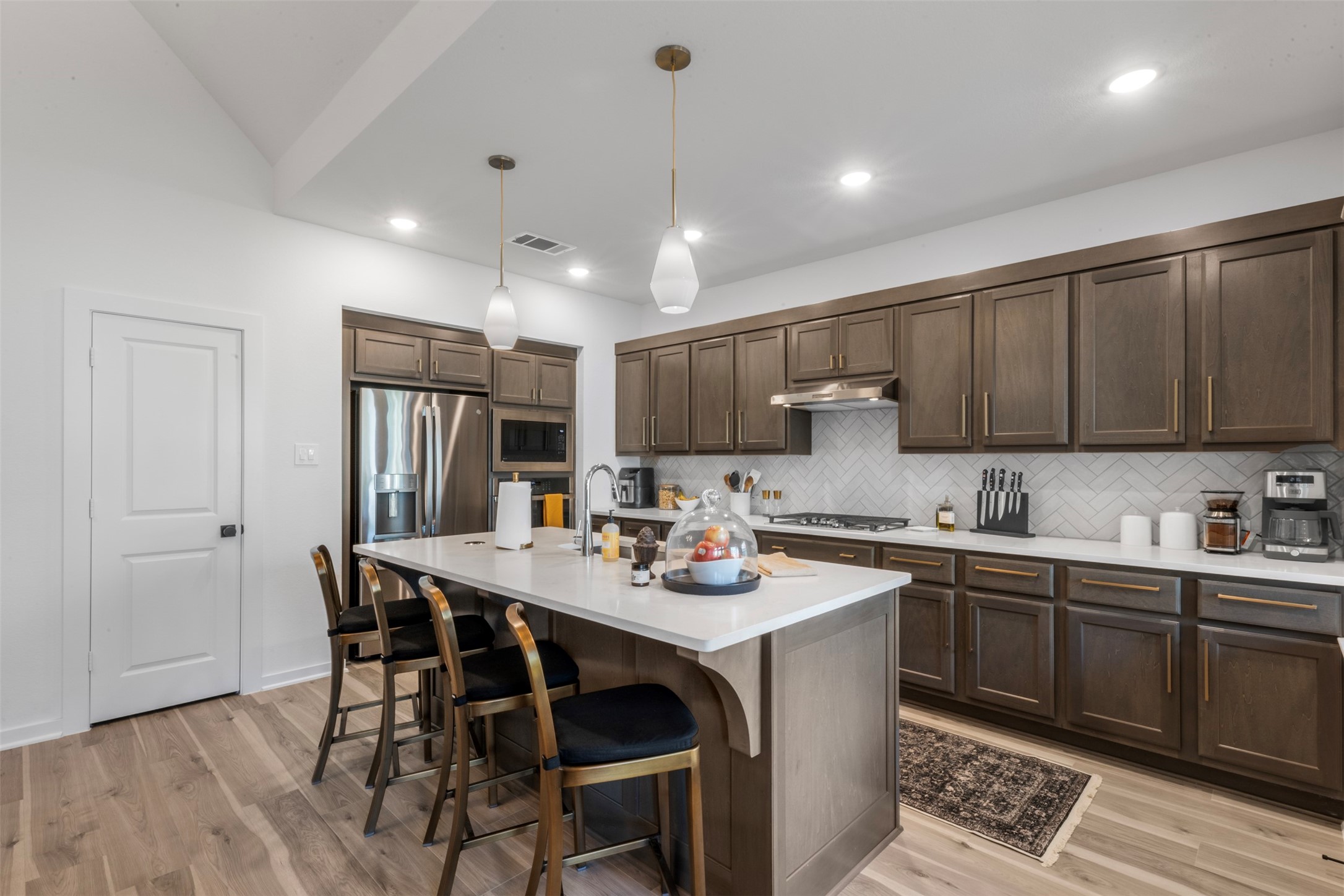 15650 Turtlehead Trail Conroe, TX 77302 - Photo 12 of 37 a kitchen with a dining table chairs sink and cabinets